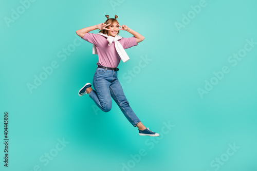 Full size photo of young happy smiling positive cheerful good mood girl showing v-sign isolated on teal color background