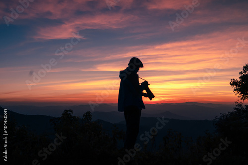 A photographer taking a picture after the sunset