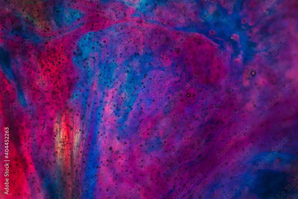 Abstract space background made of epoxy resin, macro photography in violet and blue shades. Copyspace.
