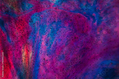 Abstract space background made of epoxy resin, macro photography in violet and blue shades. Copyspace.