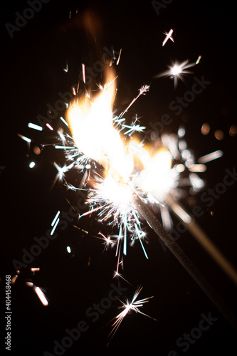 Sparkling firecrackers burning close up shot isolated on black boken shallow depth of field