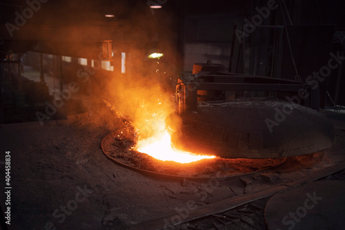 Industrial electric arc furnace in foundry. Iron being extracted out of ore for steel production. Metallurgy and heavy industry.