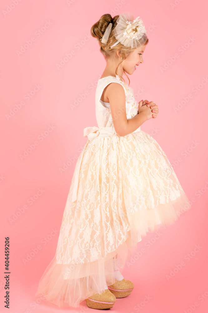 little princess in white dress isolated on pink background little princess in white dress isolated on pink background
