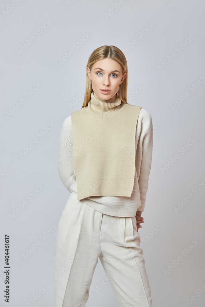 Blonde woman with a shirt front around her neck. Clothing for autumn weather. Beautiful natural makeup Blonde woman with a shirt front around her neck. Clothing for autumn weather. Beautiful natural makeup