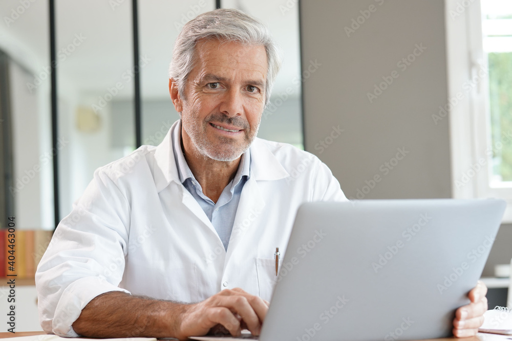 Portrait of attractive mature doctor working in office Portrait of attractive mature doctor working in office