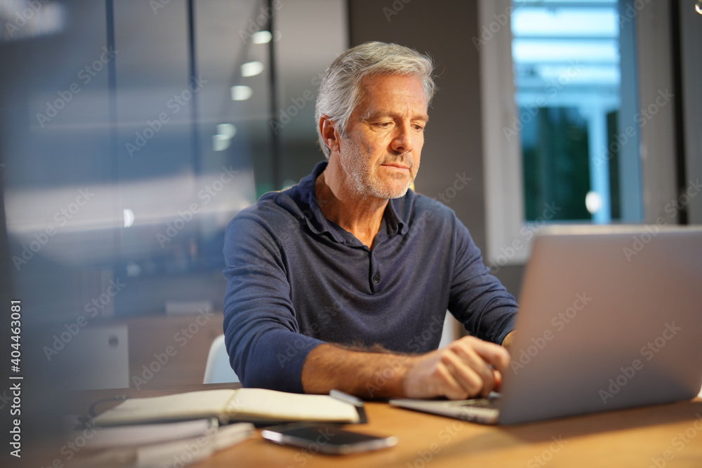 Portrait of senior man with grey hair connected with laptop Portrait of senior man with grey hair connected with laptop