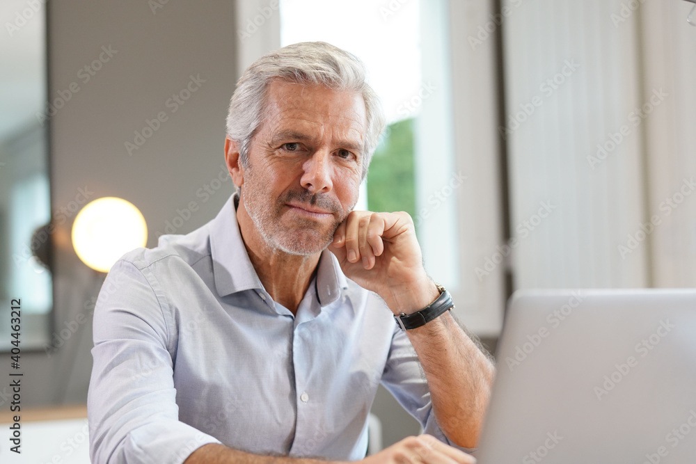 Portrait of handsome senior businessman working on laptop Portrait of handsome senior businessman working on laptop
