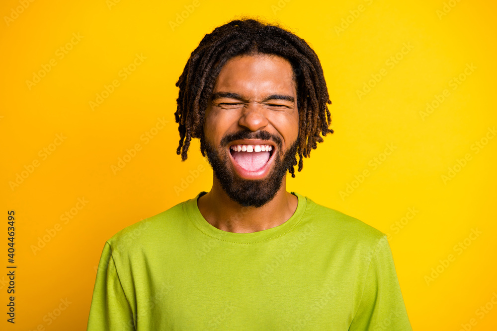 Portrait of comic dark skin guy close eyes scream wear casual summer clothes isolated vibrant yellow color background Portrait of comic dark skin guy close eyes scream wear casual summer clothes isolated vibrant yellow color background
