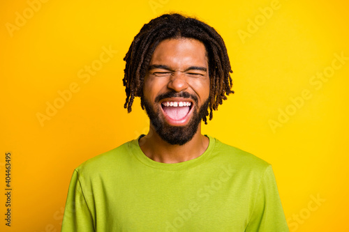 Portrait of comic dark skin guy close eyes scream wear casual summer clothes isolated vibrant yellow color background © deagreez