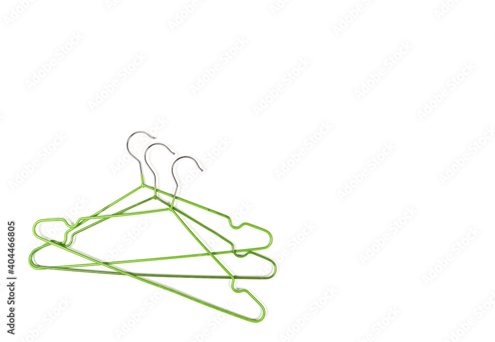 Metal clothes hangers on a light background. Wardrobes were hung for clothes. Place for text Metal clothes hangers on a light background. Wardrobes were hung for clothes. Place for text
