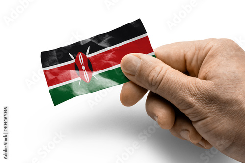 Hand holding a card with a national flag the Kenya