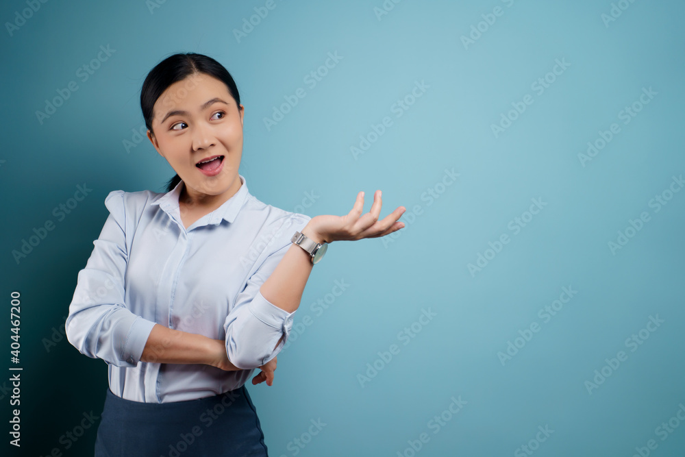 Asian woman happy surprised isolated on blue background. Asian woman happy surprised isolated on blue background.