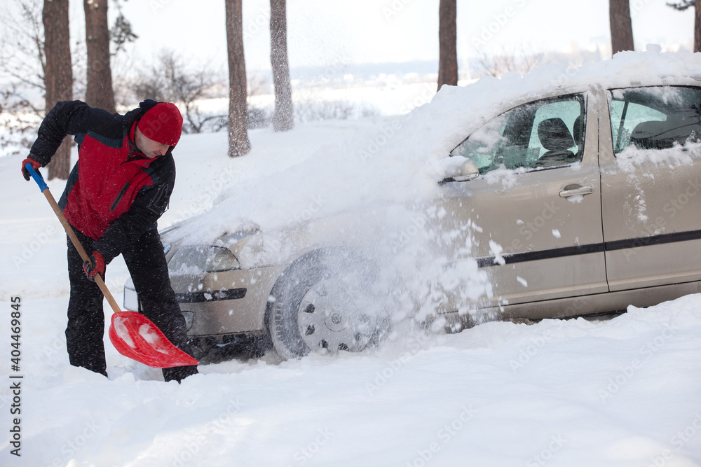shoveling snow from car, man shoveling snow - obrazy, fototapety, plakaty 