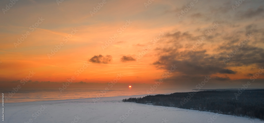 Sunset over winter gulf of finland, baltic sea