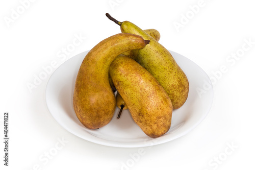 Yellow pears of variety Conference on a white dish