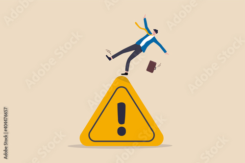Mistake caution, business risk or problem warning, failure prevention or avoid danger concept, cautious businessman slip falling on exclamation symbol beware, careful caution sign. photo