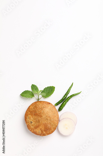 Kachori  green chilly and onion on white background. kachori is a spicy snack from India also spelled as kachauri and kachodi.