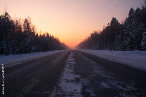 The road through snow and frost. A deserted track in the North in severe frost is a test for a car and a person. © Илья Юрукин
