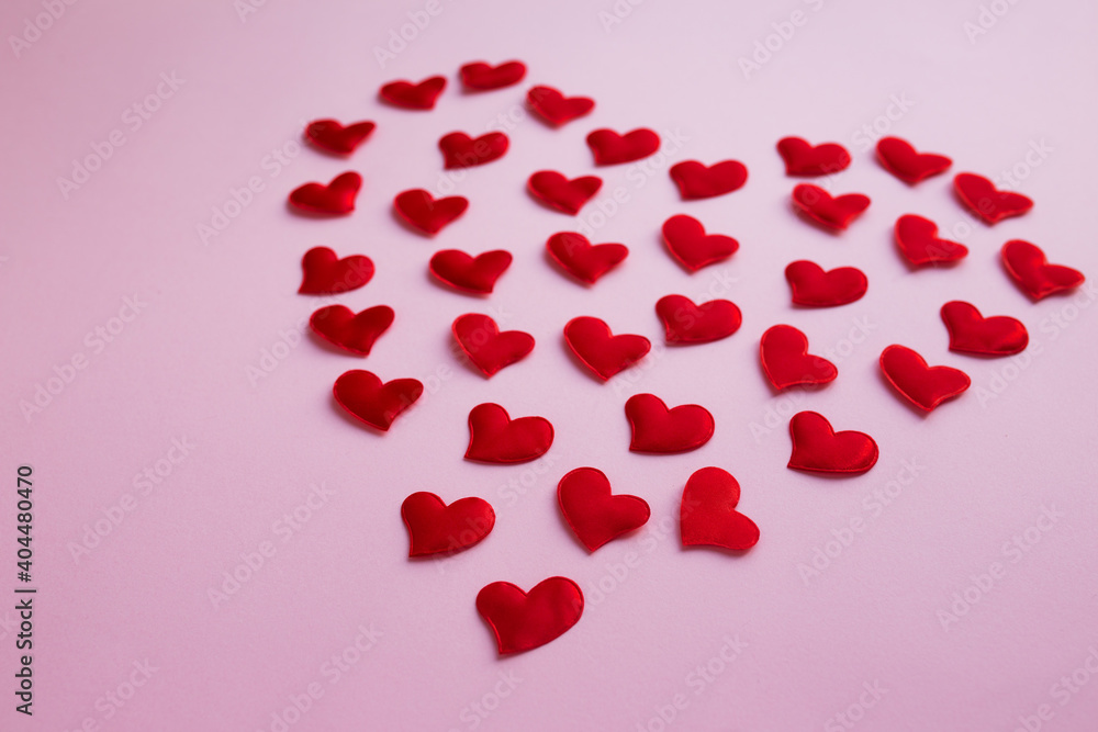 Heart shape made of small red hearts on pink background. Valentines,love and wedding concept
