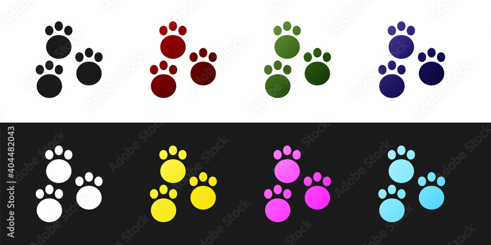 Fototapeta premium Set Paw print icon isolated on black and white background. Dog or cat paw print. Animal track. Vector.