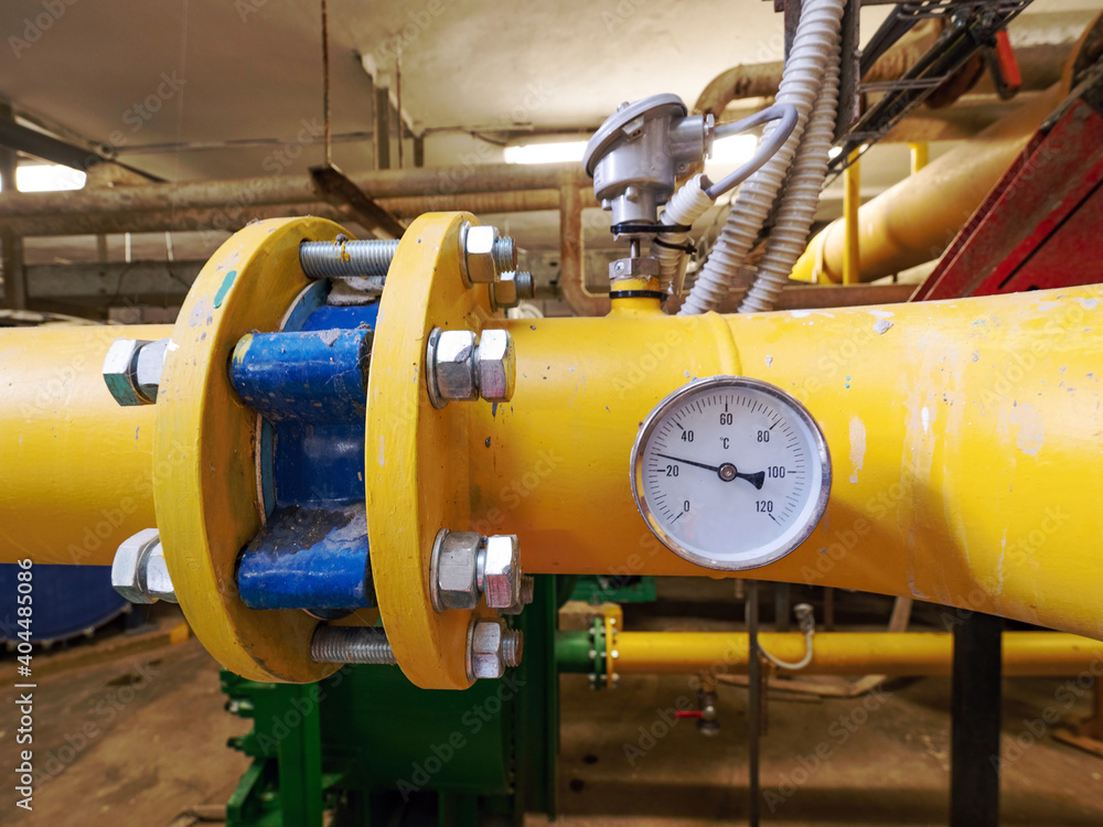 Temperature meter on yellow sludge pipeline in pumping station.