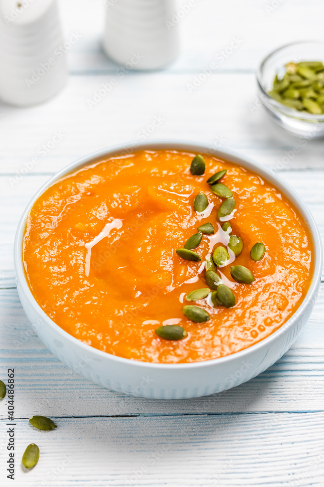 Creamy roasted pumpkin soup in a bowl. Space for text. Creamy roasted pumpkin soup in a bowl. Space for text.