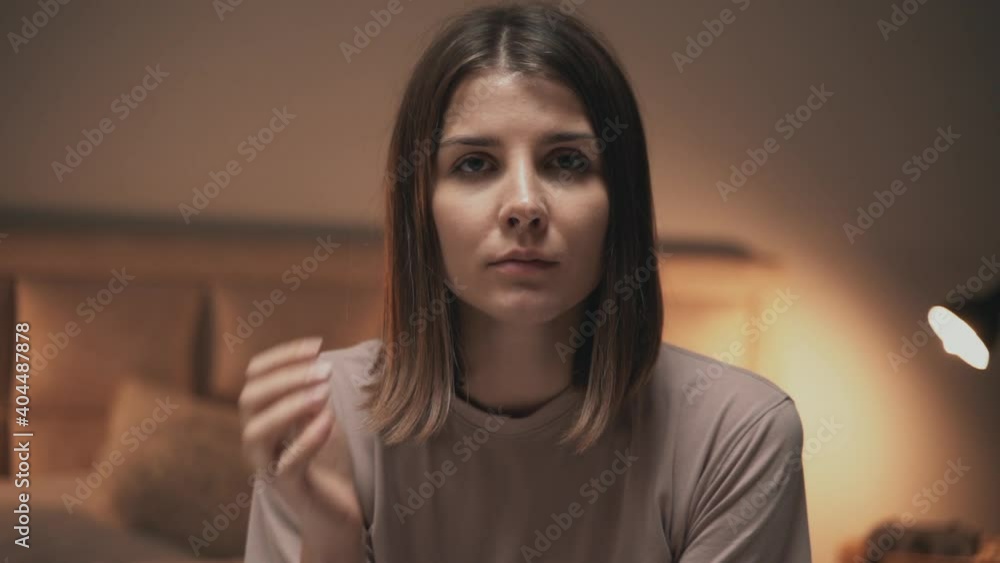 Portrait of young serious woman looking at camera indoor Portrait of young serious woman looking at camera indoor