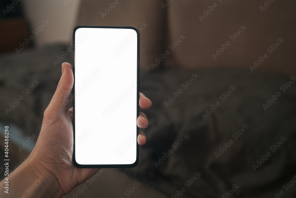 pov shot of man hand hold phone with white screen in dark interior pov shot of man hand hold phone with white screen in dark interior