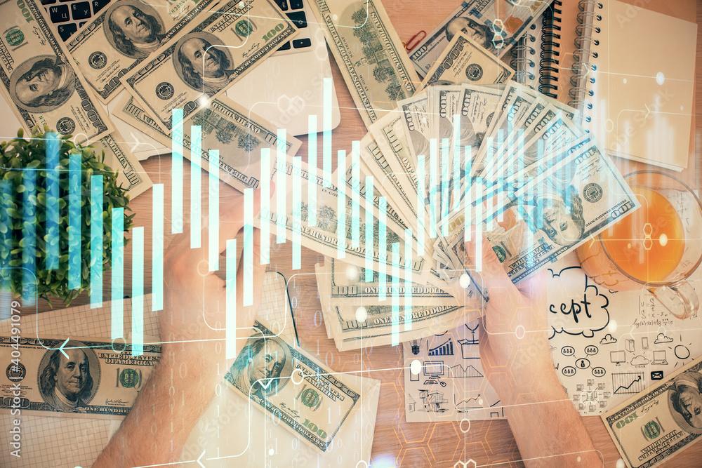 Multi exposure of financial graph drawing hologram and USA dollars bills and man hands. Analysis concept. Multi exposure of financial graph drawing hologram and USA dollars bills and man hands. Analysis concept.