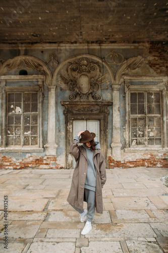 stylish young woman in a coat and hat in the old castle © Victoriya Bulyha