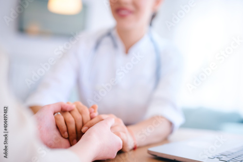 Woman doctor holds the patient's hands and supports. Medicine and health care concept. Doctor and patient