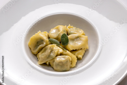ravioli del plin typical Piedmontese filled pasta from the Langhe in Italy seasoned with butter and sage and parmesan.
