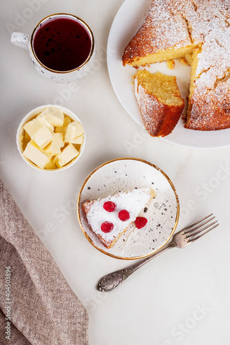 Semolina cake on a white plate. Slice of homemade sweet semolina cake with raspberries.