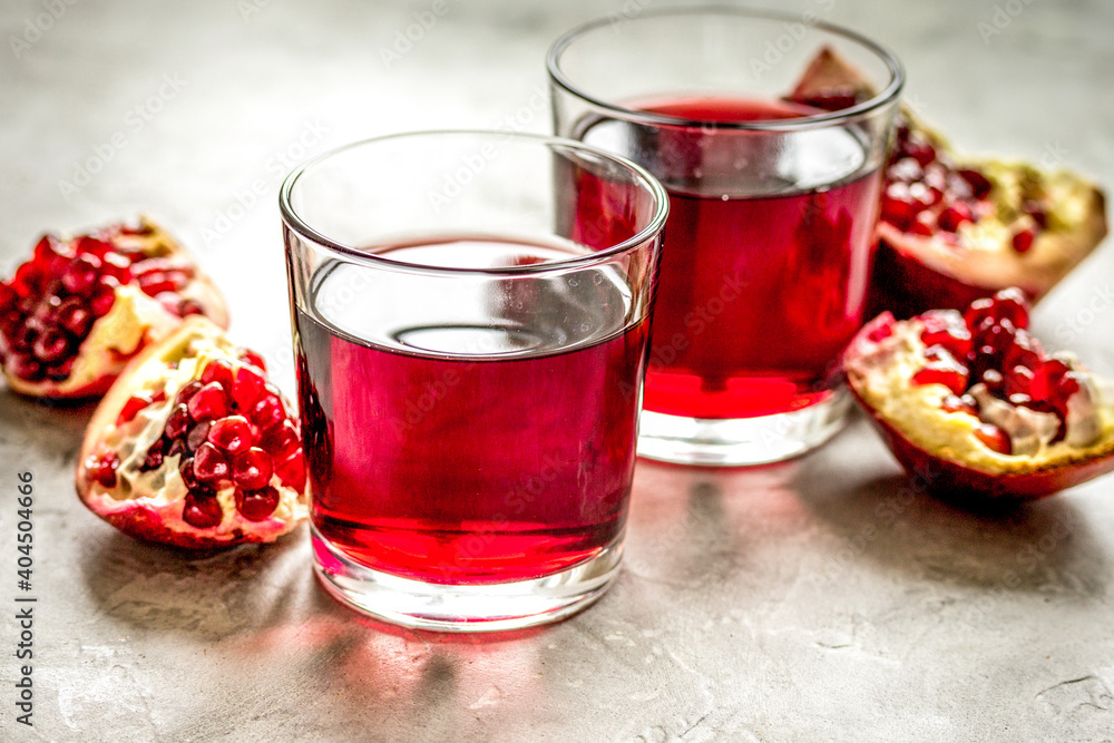 ripe pomergranate and glass of juice on table background ripe pomergranate and glass of juice on table background