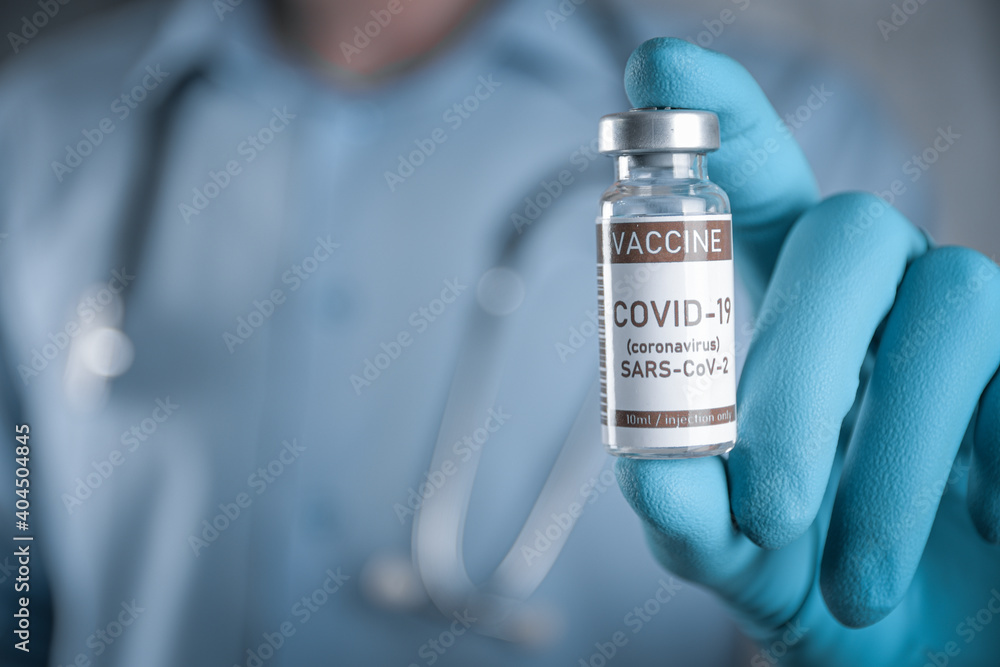 Doctor with a stethoscope on shoulder holding in hand COVID-19 , coronavirus, SARS-cov-2 vaccine. Healthcare And Medical concept.Development and creation vaccine Doctor with a stethoscope on shoulder holding in hand COVID-19 , coronavirus, SARS-cov-2 vaccine. Healthcare And Medical concept.Development and creation vaccine