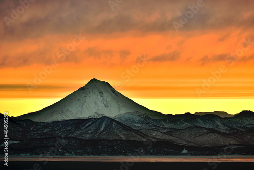Beautiful sunset on Avacha Bay against the background of Vilyuchinsky volcano in winter in Kamchatka