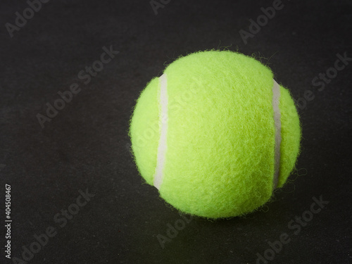 Sport and healthy lifestyle. Tennis. Yellow ball for tennis and a racket on table. Sports background with tennis concept. © Mikhail