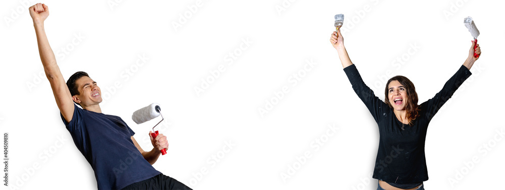 Happy young woman and man with raised arms holding paint brush and paint roller. Painting walls concept in horizontal banner with copy space and isolated white background. Happy young woman and man with raised arms holding paint brush and paint roller. Painting walls concept in horizontal banner with copy space and isolated white background.