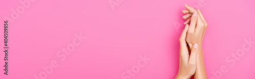 top view of groomed female hands with pastel manicure on pink background  banner