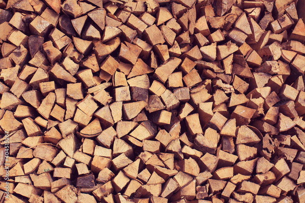 Background of dry chopped firewood logs stacked up on top of each other. Background of dry chopped firewood logs stacked up on top of each other.