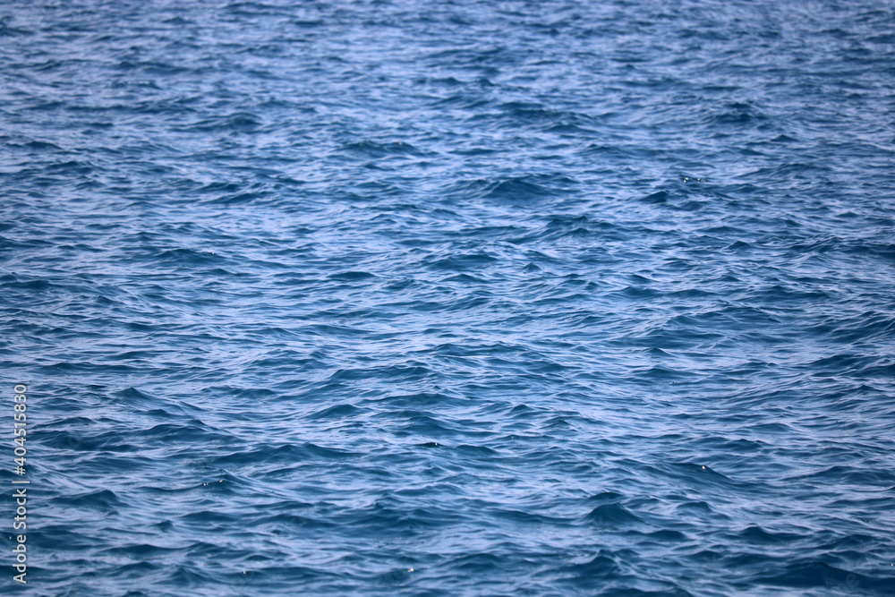 Water surface of deep blue sea. Soft waves texture, ripple water for background Water surface of deep blue sea. Soft waves texture, ripple water for background