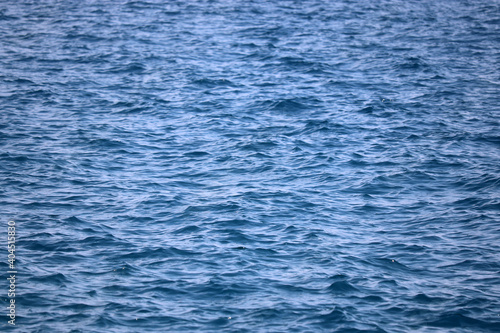 Water surface of deep blue sea. Soft waves texture, ripple water for background