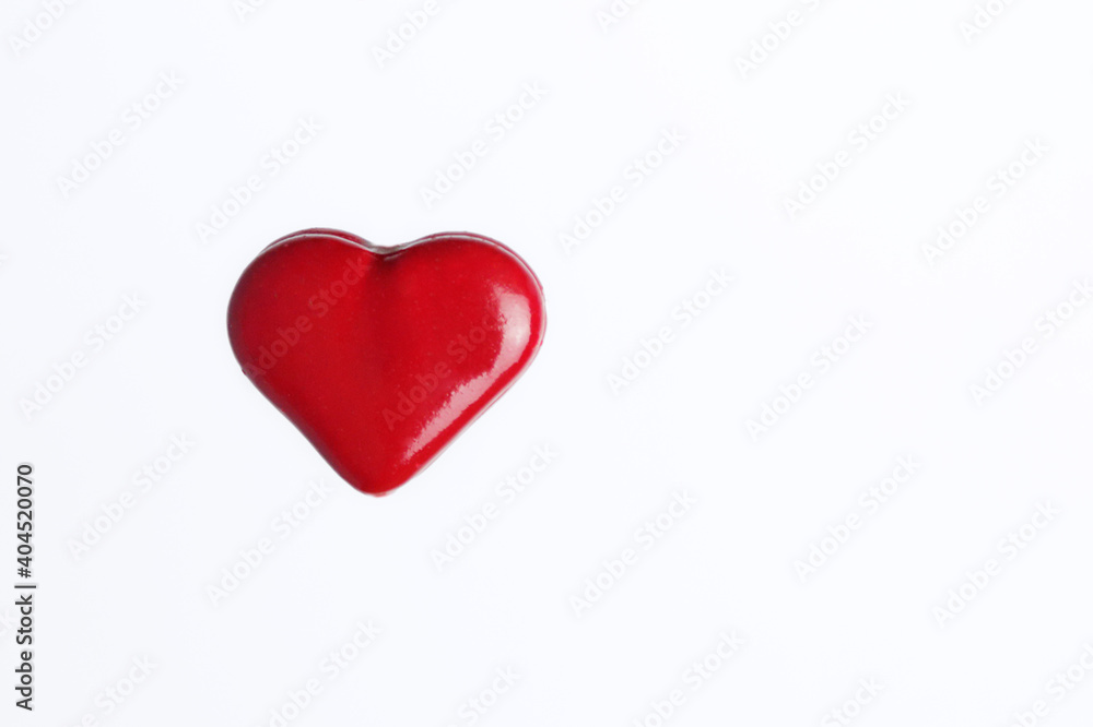 Red love heart against white background with copy space. Love concept..