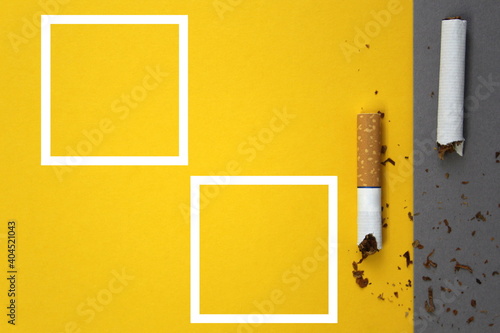 Broken cigarettes lie on gray and yellow background, concept of harmfulness of smoking photo