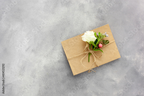 Postcard with open kraft paper envelope filled with spring flowers