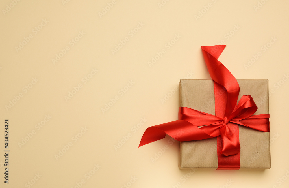 square gift box is packed in red paper and curled silk ribbon square gift box is packed in red paper and curled silk ribbon