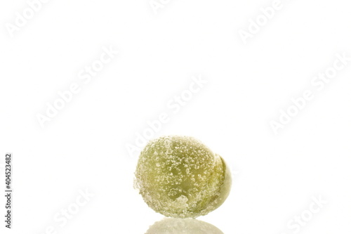Organic frozen green peas, close-up, isolated on white.