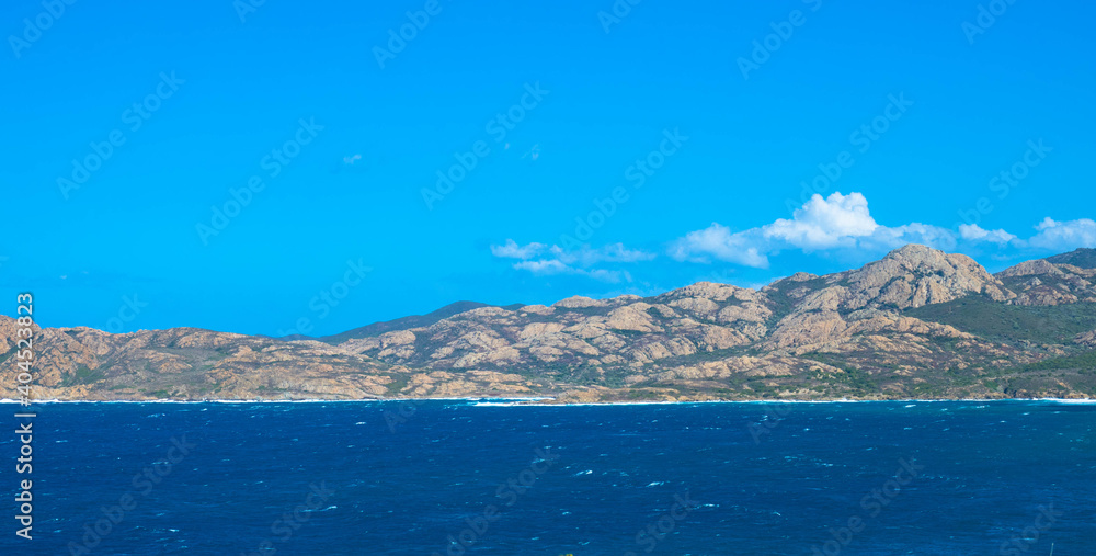 Panoramic view of the mediterranean sea with a rocky coastline and blue sky. Tourism and vacations concept. Corsica, France