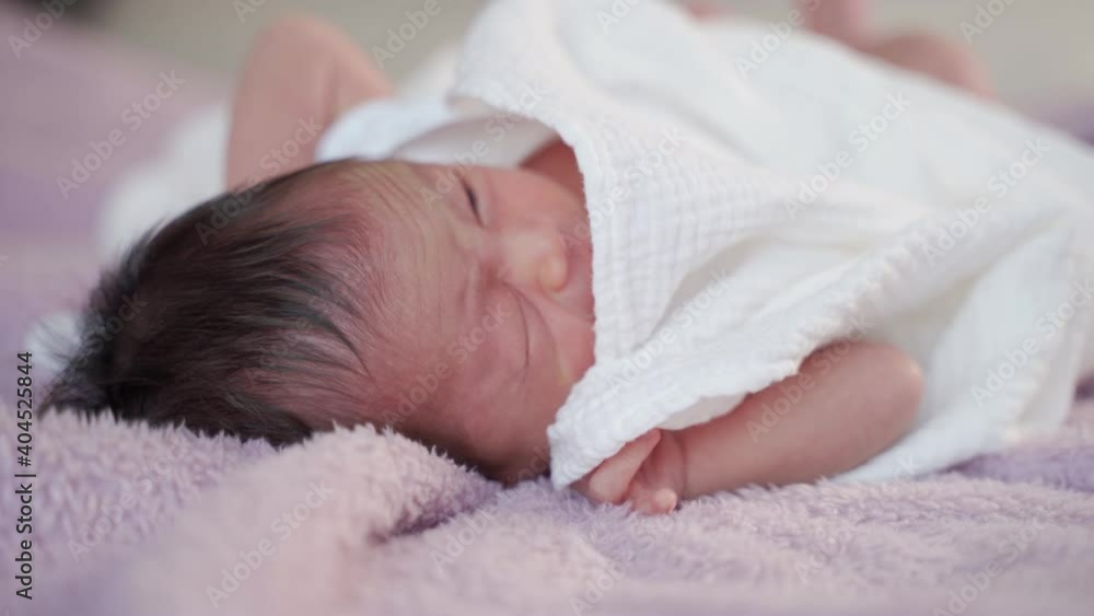 asian baby infant feels uncomfortable and cry on soft furry bed. baby wriggles in sleep. asian baby infant feels uncomfortable and cry on soft furry bed. baby wriggles in sleep.