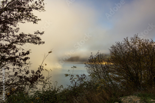 A foggy day at Lake Turano. The colors of autumn in Castel di Tora in Rieti